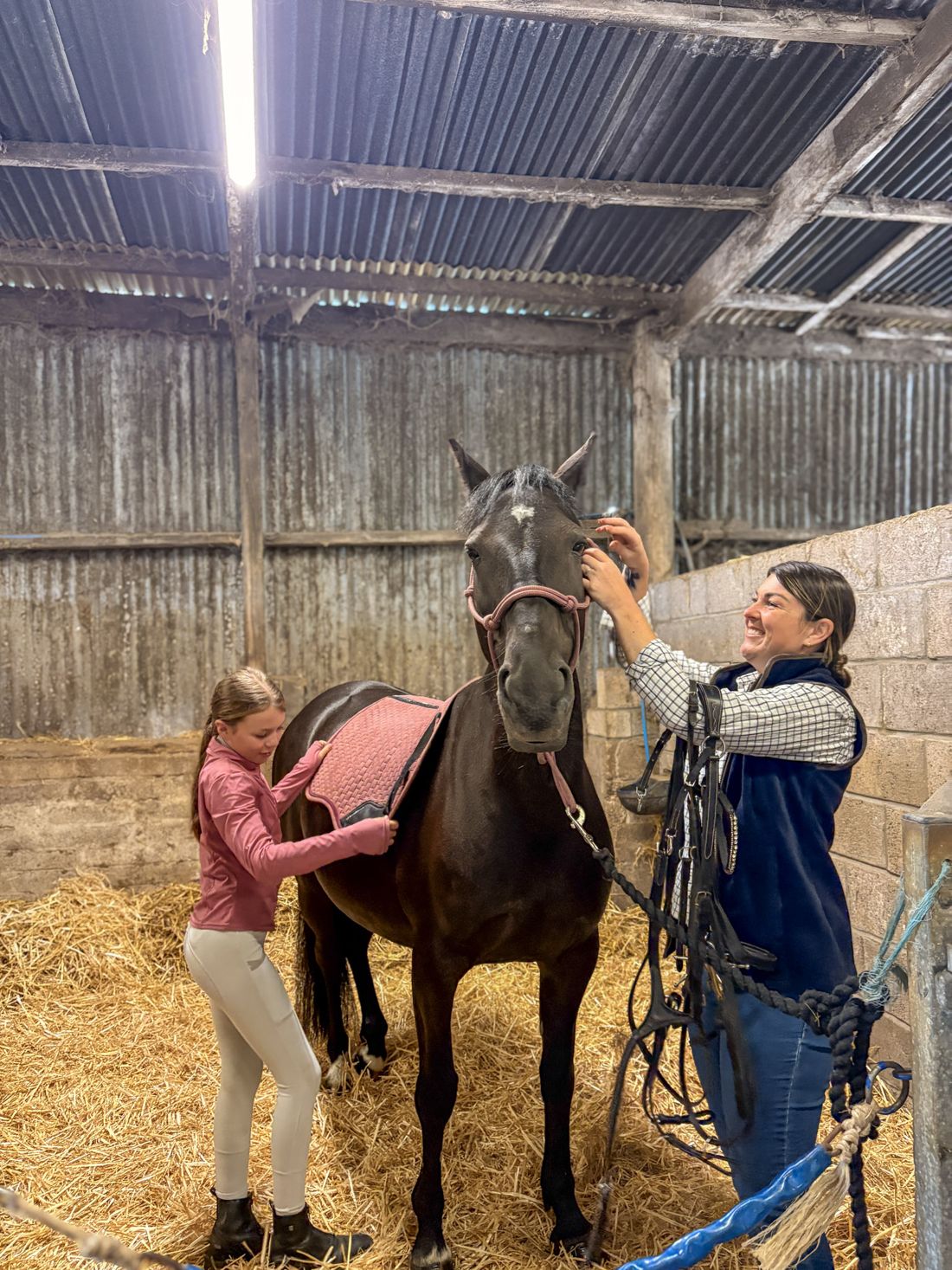 Kayleigh from The Equine Market tacking up in the stables